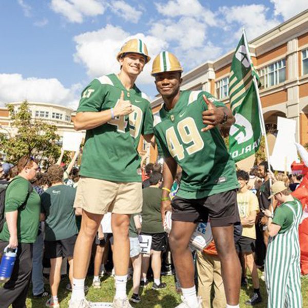 two students giving thumbs up